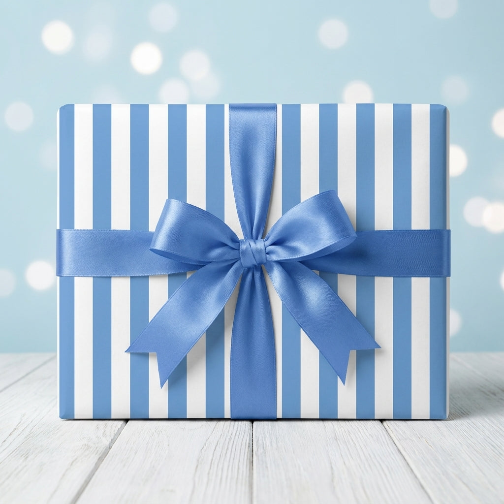 Blue striped wrapping paper with a satin bow for birthdays and baby showers by Wrapped Studios.