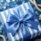 Nautical blue striped wrapping paper with a satin bow on a gift box by Wrapped Studios.
