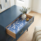 Blue and white toile wrapping paper used as a drawer liner in a blue dresser cabinet, by Wrapped Studios.