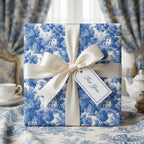 Luxury blue toile wrapping paper with a cream satin bow and gift tag by Wrapped Studios.