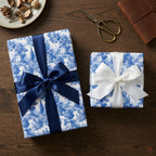 Elegant blue and white toile de jouy wrapping paper with satin ribbons by Wrapped Studios.