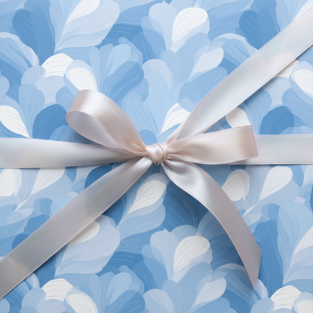 Blue floral wrapping paper with a soft pink satin bow.