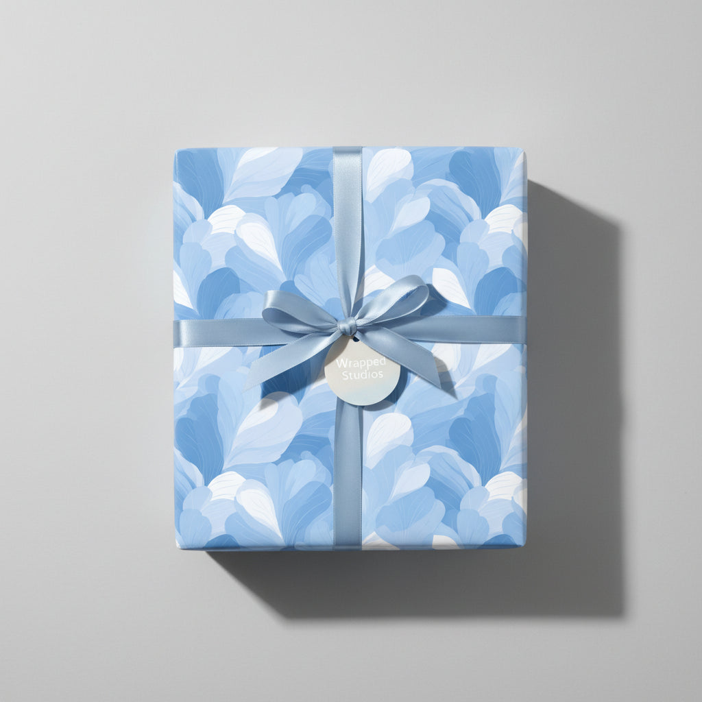 Sky-blue floral wrapping paper on a gift box with matching ribbon and tag; perfect for birthdays or baby showers.