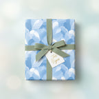 Elegant gift wrapped in blue floral wrapping paper with a green ribbon and "For You" tag.