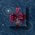 Elegant navy gift wrap with celestial map design, burgundy satin bow, and "To Our Stars" tag.
