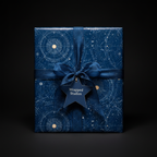 Elegant gift wrapped in blue constellation wrapping paper with satin ribbon and star tag.