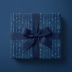 Navy blue rocket blueprint wrapping paper with a matching ribbon by Wrapped Studios.