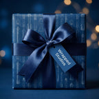 Navy blue rocket blueprint wrapping paper with satin ribbon bow and tag by Wrapped Studios.