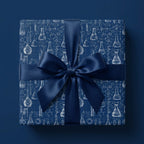 Navy blue chemistry wrapping paper with science flask pattern and satin bow, by Wrapped Studios.