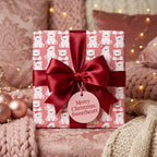 Pink polar bear Christmas gift wrap with luxury burgundy ribbon bow by Wrapped Studios.