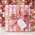 Cute polar bear pink Christmas wrapping paper on a gift box with a ribbon, by Wrapped Studios.