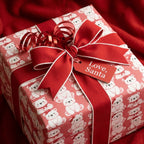 Cute polar bear Christmas wrapping paper by Wrapped Studios on a gift box with a red bow and "Love, Santa" tag.