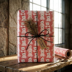 Pink polar bear Christmas wrapping paper by Wrapped Studios on a gift box tied with rustic black twine.