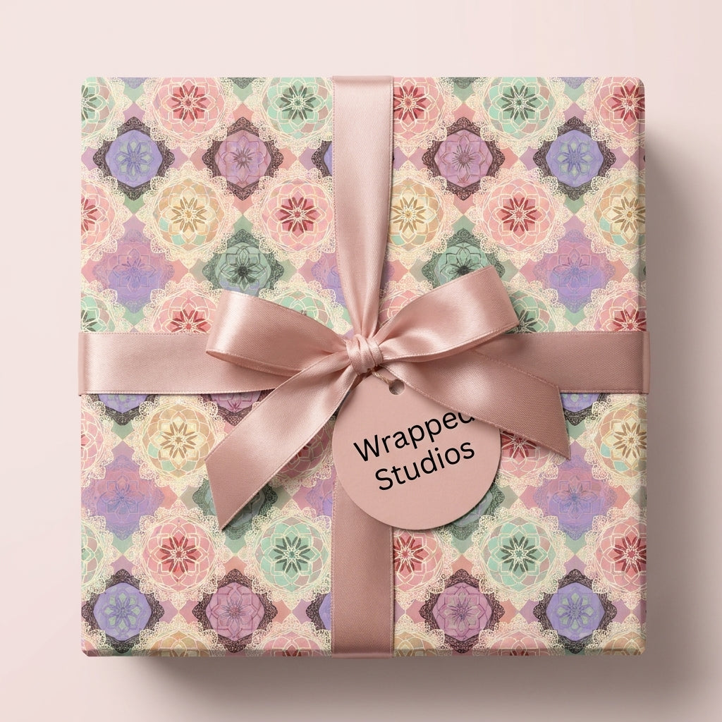 Elegant pastel mandala wrapping paper with a pink satin bow and gift tag by Wrapped Studios.