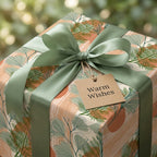 Modern botanical wrapping paper featuring green leaves, terracotta accents, and a sage ribbon by Wrapped Studios.