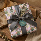 Luxury boho botanical wrapping paper by Wrapped Studios, tied with an elegant charcoal grey ribbon.