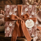 Luxury floral wrapping paper with a terracotta velvet ribbon and gift tag by Wrapped Studios.