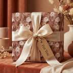 Dusty rose floral wrapping paper with cream satin ribbon on a wedding gift box by Wrapped Studios.
