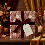 Luxury boho floral wrapping paper with a burgundy velvet ribbon on a wedding gift by Wrapped Studios.