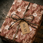 Vintage floral wrapping paper with a rustic rose print and twine bow by Wrapped Studios.