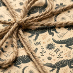 Rustic alligator wrapping paper with botanical prints and a jute twine bow by Wrapped Studios.