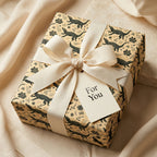 Alligator wrapping paper with a cream bow and 'For You' tag. Luxury gift wrap by Wrapped Studios.