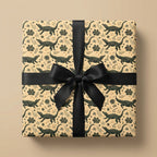 Alligator wrapping paper with a black ribbon bow by Wrapped Studios. Whimsical crocodile birthday gift wrap.