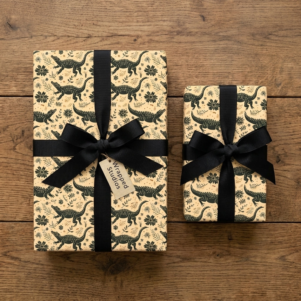 Alligator wrapping paper with black ribbon bows on a wooden table by Wrapped Studios.