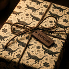 Rustic alligator wrapping paper with twine and a wooden explore tag by Wrapped Studios.