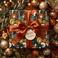 Luxury Christmas wrapping paper with diverse women illustrations and copper ribbon by Wrapped Studios.