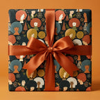 Retro holiday wrapping paper with illustrated Black women and a satin orange bow, by Wrapped Studios.