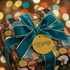 Luxury Christmas wrapping paper by Wrapped Studios with diverse women pattern, teal velvet ribbon and Merry tag.