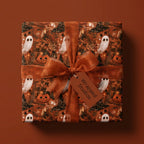Spooky ghost and pumpkin Halloween wrapping paper with matching rust ribbon by Wrapped Studios.