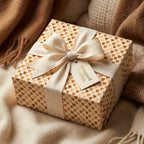 Boho neutral heart wrapping paper on a cozy gift box with a cream bow by Wrapped Studios.