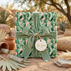 Boho cactus wrapping paper in pink and green with a sage velvet bow by Wrapped Studios.