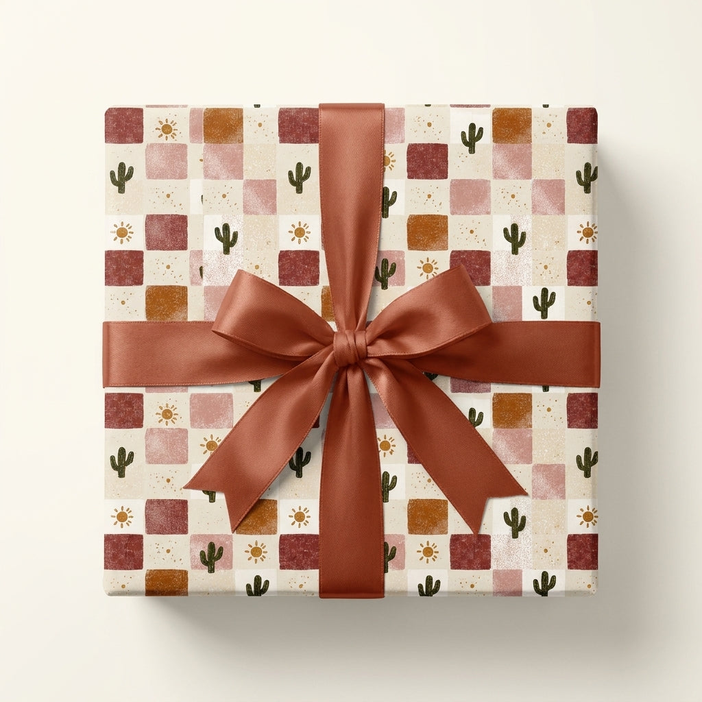 Boho desert wrapping paper by Wrapped Studios featuring a terracotta cactus checkerboard pattern and a satin bow.
