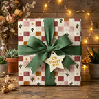 Terracotta boho cactus birthday wrapping paper with a green bow, by Wrapped Studios.