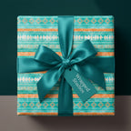 Boho southwest wrapping paper in teal and orange with a satin bow by Wrapped Studios.