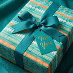 Boho geometric wrapping paper in teal and orange with ribbon and "For You" gift tag by Wrapped Studios.