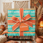 Boho wrapping paper with teal and terracotta southwestern patterns and a big bow by Wrapped Studios.