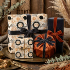 Celestial wrapping paper with vintage sun and moon designs, styled with luxury velvet ribbons by Wrapped Studios.