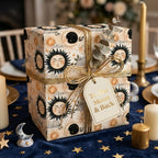 Vintage celestial sun and moon wrapping paper with a gold ribbon by Wrapped Studios.