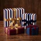 Luxury navy and burgundy striped wrapping paper with elegant velvet and satin bows by Wrapped Studios.