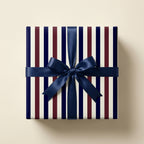 Luxury navy blue and burgundy striped wrapping paper with a blue satin bow, by Wrapped Studios.