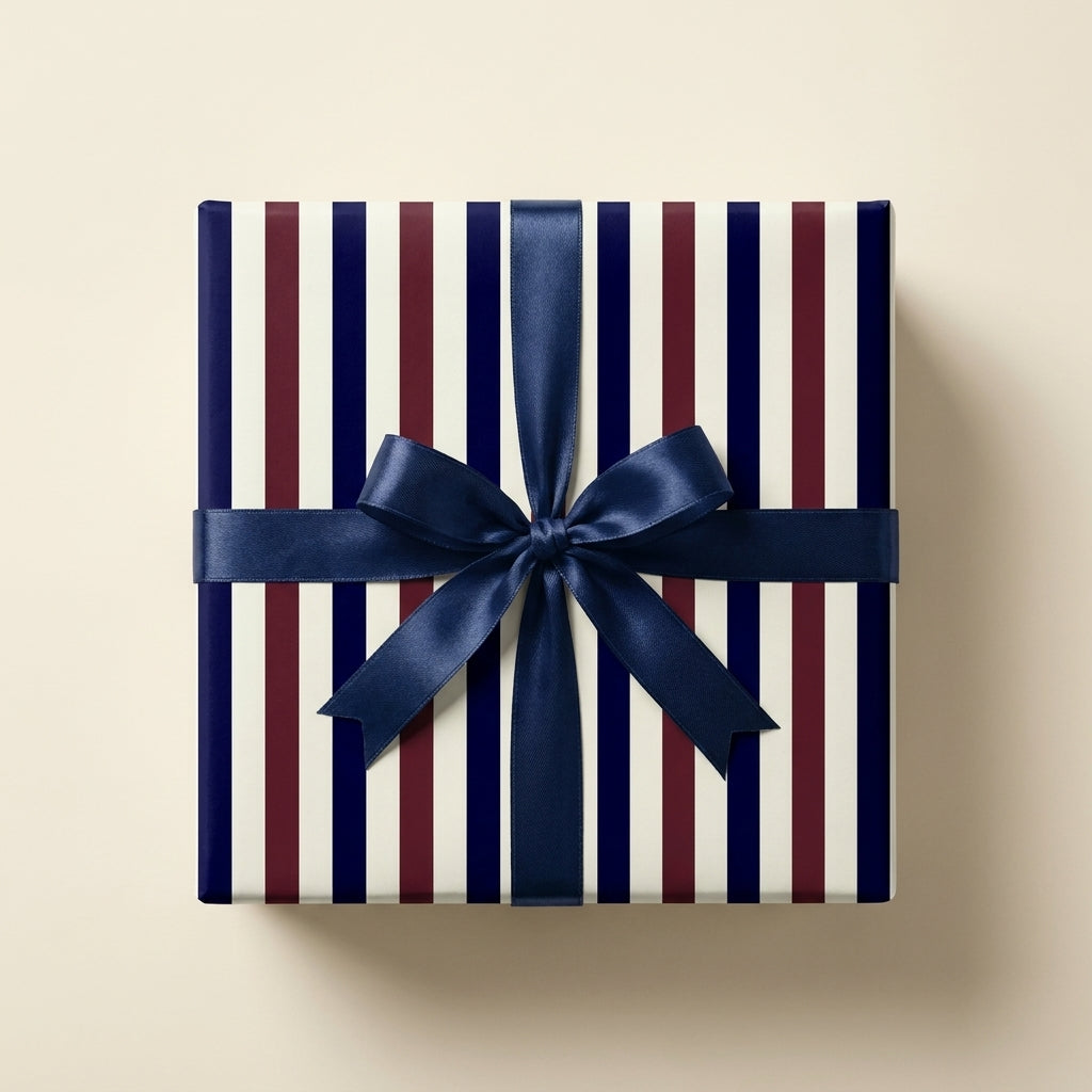 Luxury navy blue and burgundy striped wrapping paper with a blue satin bow, by Wrapped Studios.