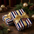 Luxury striped Christmas wrapping paper in navy and burgundy with gold bows, by Wrapped Studios.