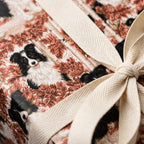 Border Collie dog wrapping paper with autumn leaves and a cream ribbon bow, by Wrapped Studios.