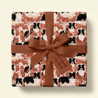 Border Collie dog wrapping paper with brown ribbon on a gift box. Pet gift wrap by Wrapped Studios.
