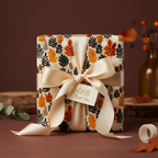 Gift wrapped in fall leaf print wrapping paper with cream ribbon and tag.