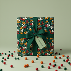 Square gift wrapped in floral Christmas gift wrap with green ribbon and "A Special Gift" tag.